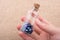 Hand holding Evil eye bead in bottle