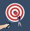 A hand holding a flashlight uncovering hidden target. Business concept vector