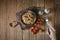 Hand holding the fork with Italian spaghetti pasta, mussel, tomato and garnish on round dish and wooden plate