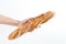 Hand holding a French baquette bread