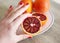 Hand holding fresh oranges - tarocco blood orange - sanguine orange