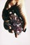 Hand holding gemstone Amethyst closeup with rock Quartz crystals.