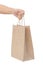 Hand holding and giving paper bag isolated over white background