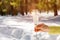 A hand holding a glass of fizzing champagne against the snowy winter background.