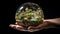 Hand holding a glass globe representing sustainability