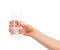 Hand holding glass with white effervescent tablet in water