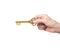 Hand holding golden treasure key in dollar sign shape