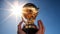 Hand holding golden trophy under the sunlight with blue sky background