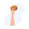 The hand is holding a hamburger. Vector isolated illustration. Minimalistic flat style. Vector for advertising fast food