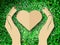 Hand holding heart love the nature symbol Grass background