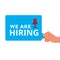 Hand holding WE ARE HIRING message. Hire announce on the bubble speech.