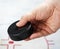 Hand holding a hockey puck on ice