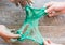 Hand holding homemade green slime with tinsel