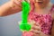 Hand holding homemade toy called Slime, kids having fun and being creative by science experiment