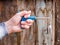 Hand holding key for replacing a car candle on a wooden background, Husky Metric Drive Ratcheting