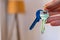 hand holding keys with room on background. rent sell buy apartment real estate business