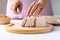 Hand holding knife and cutting organic tofu for cooking