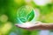 Hand holding with leaf icons in the Earth Network connection on nature background, Technology ecology concept. Environmental