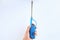 Hand holding long lighter Blue gas lighter  on white background. Household lighter for gas stoves in the kitchen with a pu