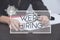 Hand holding magnifier with we`re hiring text. concept employmen