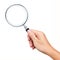 Hand holding magnifying glass isolated