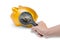 Hand Holding magnifying glass is shines coin in pork bellies on white background.