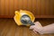 Hand Holding magnifying glass is shines coin in pork bellies on wood background.