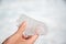 Hand holding a melting piece of ice on Athabasca glacier in Columbia Icefield, Jasper National park, Rocky Mountains Alberta, Ca