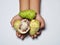 Hand holding mengkudu or noni fruits on white background