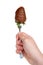 Hand holding Milk chocolate covered strawberry drizzled in milk chocolate on a small fork