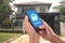 Hand holding mobile phone with concept technology home security