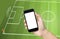 Hand holding mobile phone, view live soccer euro game on mobile