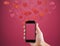 Hand holding Mobile smart phone, with floating hearts. Valentines, love message and texting concept