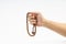 Hand holding a muslim rosary beads or Tasbih on white background.