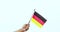 Hand holding national flag of German country