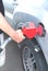 Hand holding a nozzle while fueling car