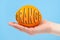 Hand holding organic delicious orange Isolated on blue Background. Healthy eating and dieting concept. Word ORANGE