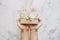 Hand holding parcel gift box, on white marble stone table background