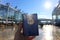 Hand holding a passport standing in front of an airplane