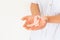 Hand holding Peach color ribbon on white background with copy space, symbol for Uterine and Endometrial cancer awareness, World