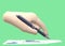 A hand holding a pen writing on a paper of sales report