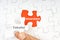 Hand holding piece of jigsaw puzzle with word TAKAFUL INSURANCE