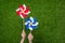 Hand holding pinwheels over grass