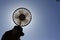 Hand holding a portable rechargeable electric fan