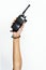 Hand holding portable two way radio on white
