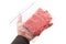 Hand holding a portion of beef ground beef