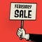 Hand holding poster, business concept with text February Sale