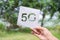 Hand holding poster cord white paper with text 5G