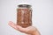 Hand holding a pot of buckwheat agaonst white background, national russian food symbol of crisis and economy, food