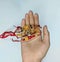 A hand holding Rakhi on hand on the event of rakshabandhan in India.